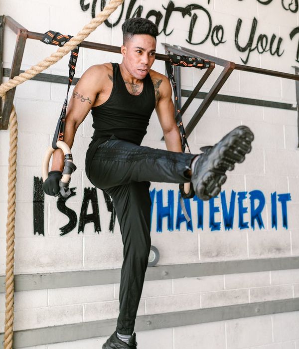 Man performing a controlled strength exercise in a calm, focused environment.